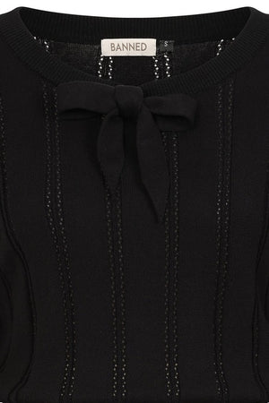 Black sweater with a bow detail and 'BANNED' label on a black background