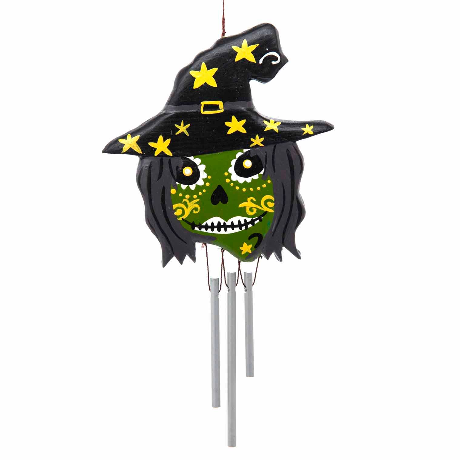 Decorative witch wind chime with black hat and green face on a white background