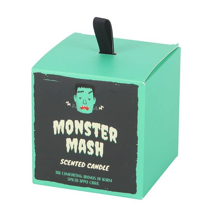 Green box with 'Monster Mash' scented candle label on a white background