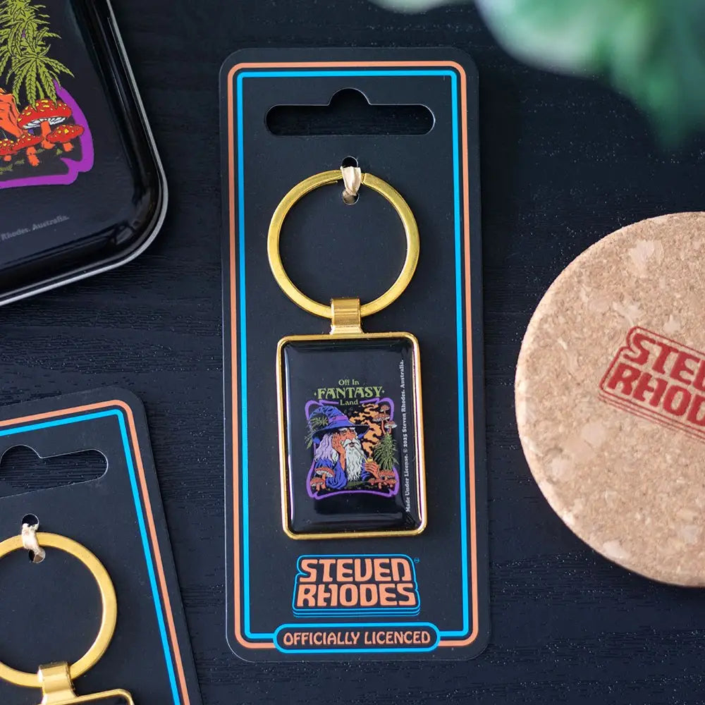 Keychain in packaging with 'Steven Rhodes' branding on a dark surface