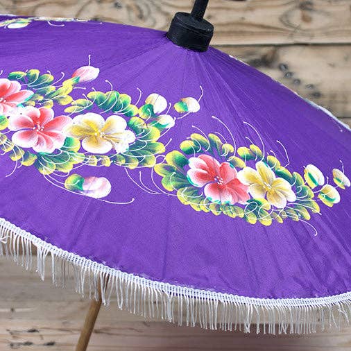 Decorative umbrella with floral design on a purple background