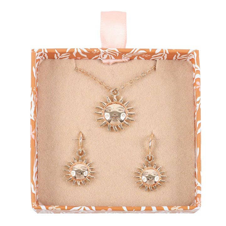 Jewelry set with sun-shaped pendant on a patterned card
