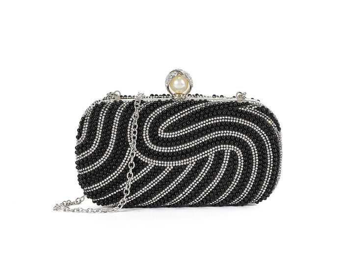 Black beaded clutch with a pearl clasp on a white background