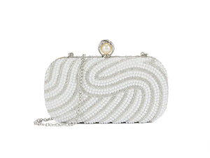 White beaded clutch bag with a pearl clasp on a white background