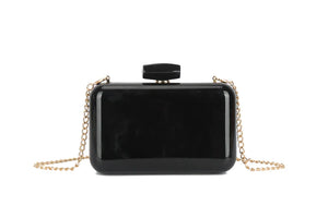 Black rectangular clutch bag with a gold chain on a white background