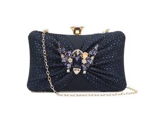 Navy blue clutch bag with decorative elements on a white background