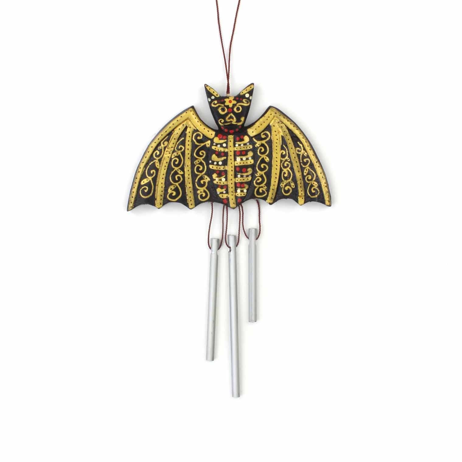 Decorative bat-shaped wind chime with intricate design on a white background