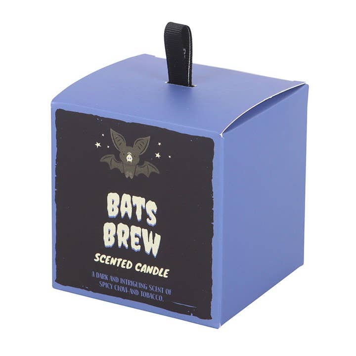 Candle in a blue box with 'Bats Brew' text and bat design on a white background