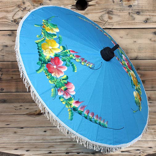 Decorative umbrella with floral design on a wooden surface